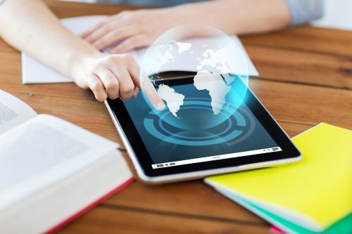 education, technology, communication and international concept - close up of student woman with earth globe hologram over tablet pc computer and notebook at home